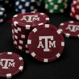 Stacks of maroon and white poker chips printed with the Texas A&M ATM logo