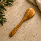 Small olive wood ladle with a rounded bowl and hanging hole, handmade cooking utensil