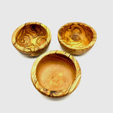 Three olive wood pinch bowls from above, small handmade prep and spice bowls