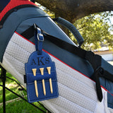 Navy leather golf tee holder engraved with sample three letter monogram initials, holding tees