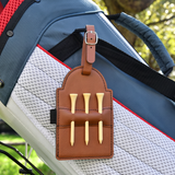 Plain tan leather golf tee holder with three wooden tees, clipped to a golf bag