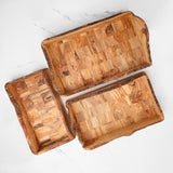Three rustic olive wood serving trays in different sizes made from patchwork olive wood blocks