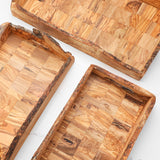 Close-up of two rustic olive wood trays showing the end grain block pattern and raw edges