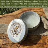 Open tin of beeswax wood polish on an olive wood board, a care add-on for olive wood bowls