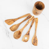 Five essential olive wood utensils, spatula, spoons and slotted spoon, fanned beside the holder