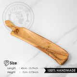 Long olive wood serving board with handle, about 40 cm long and 7 cm wide
