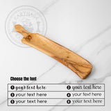 Olive wood charcuterie board with a font chart showing six text styles for personalization