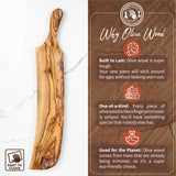 Long olive wood serving board standing upright beside a why olive wood card