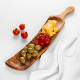 Handmade olive wood charcuterie board with handle holding olives, cheese cubes and cherry tomatoes